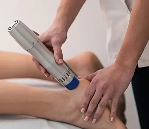 Shockwave therapy treatment on patient's knee